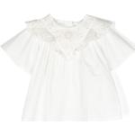 Blusas blancas de popelín de cuello redondo infantiles con logo con volantes de materiales sostenibles 