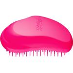 Cepillos y peines rosas para  cabello seco 